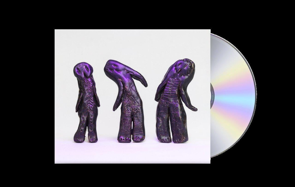 Three purple, textured, clay-like figures standing on a white background next to a CD.