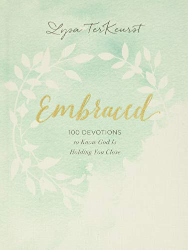 Book cover with floral wreath and title “Embraced” in gold lettering.