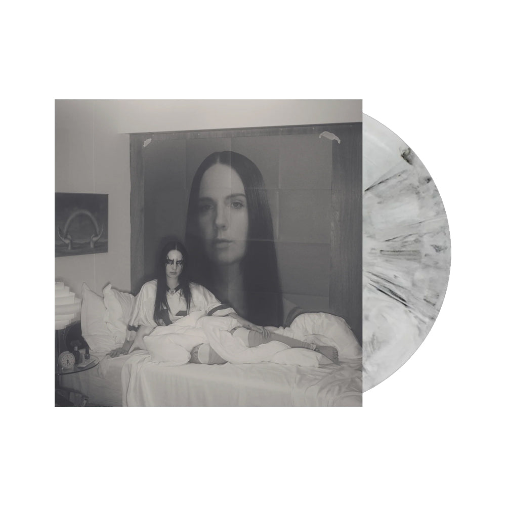 Black and white photo of a woman in a bedroom, with a ghostly overlay.