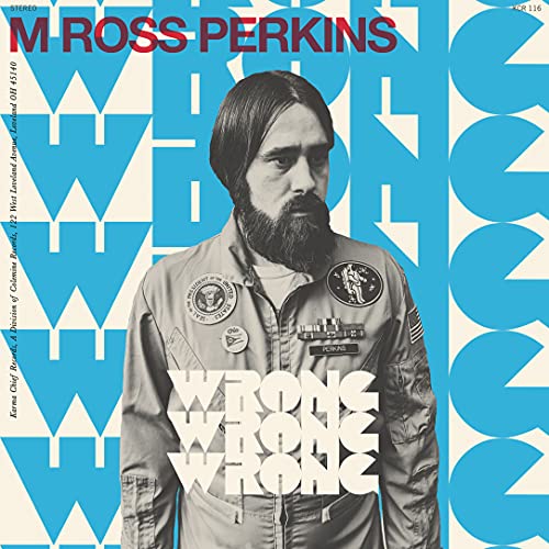 Vinyl record cover featuring a bearded man in a flight suit.