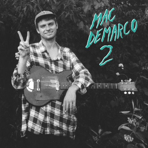 "Black and white album cover with Mac DeMarco holding a guitar, giving a peace sign."
