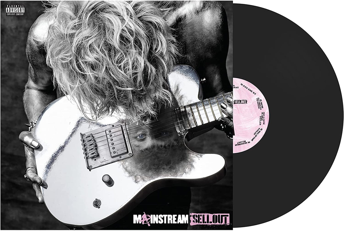 Black and white photo of Machine Gun Kelly leaning over a reflective electric guitar.
