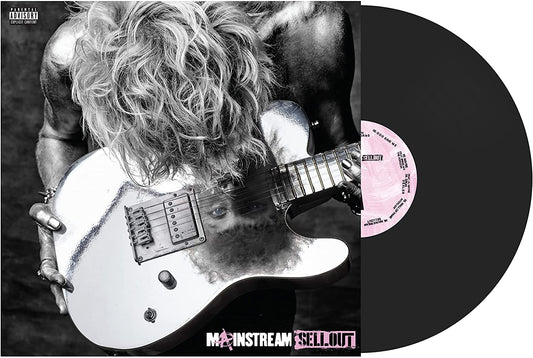Black and white photo of Machine Gun Kelly leaning over a reflective electric guitar.