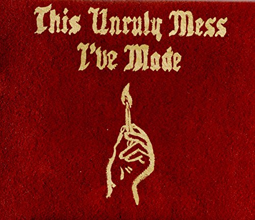 Red album cover with gold text and a hand holding a lit match.