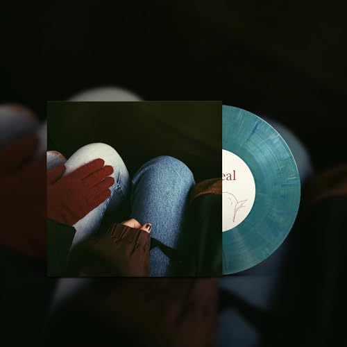 Vinyl record with album art of legs and a gloved hand.