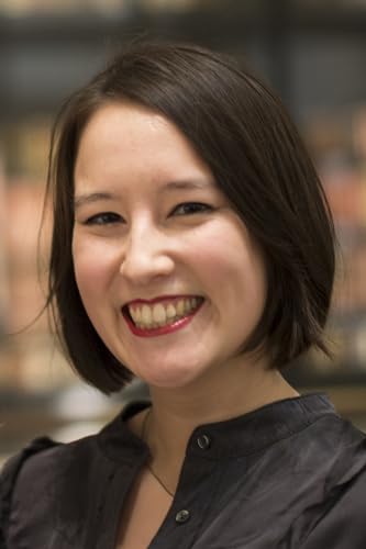 Smiling woman with short brown hair, likely the author of “Bound.”