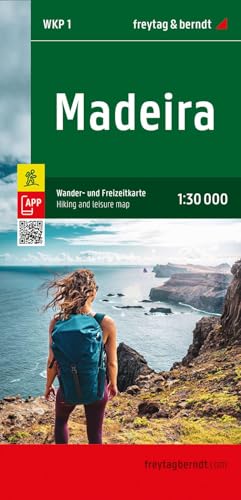 A hiker with a backpack looks out over the ocean and cliffs of Madeira.