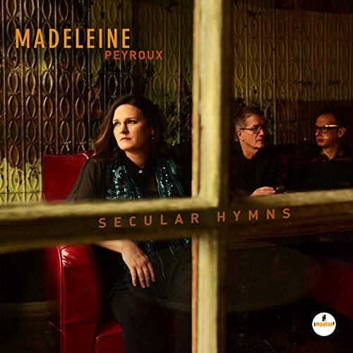 Madeleine Peyroux album cover, "Secular Hymns," featuring musicians in a dimly lit room.