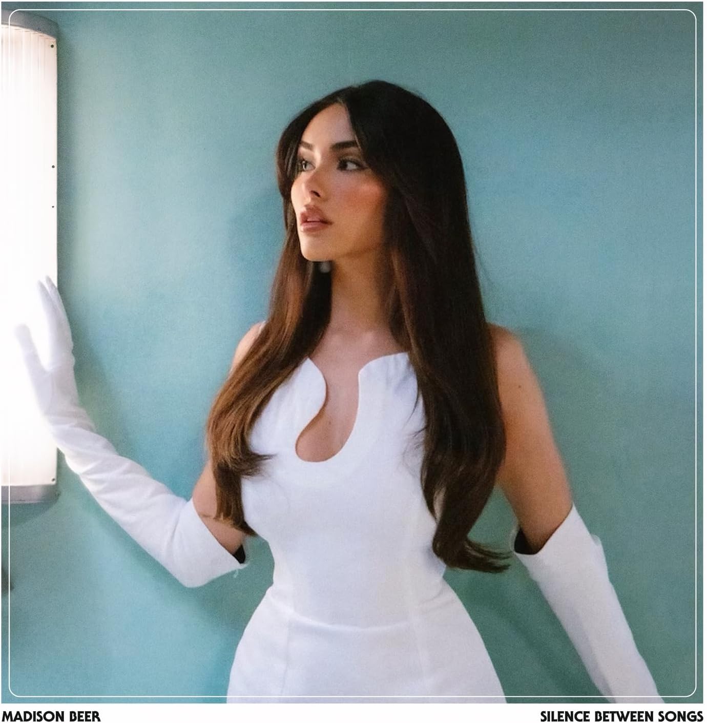 Madison Beer album cover, portrait of a woman in white, teal background.
