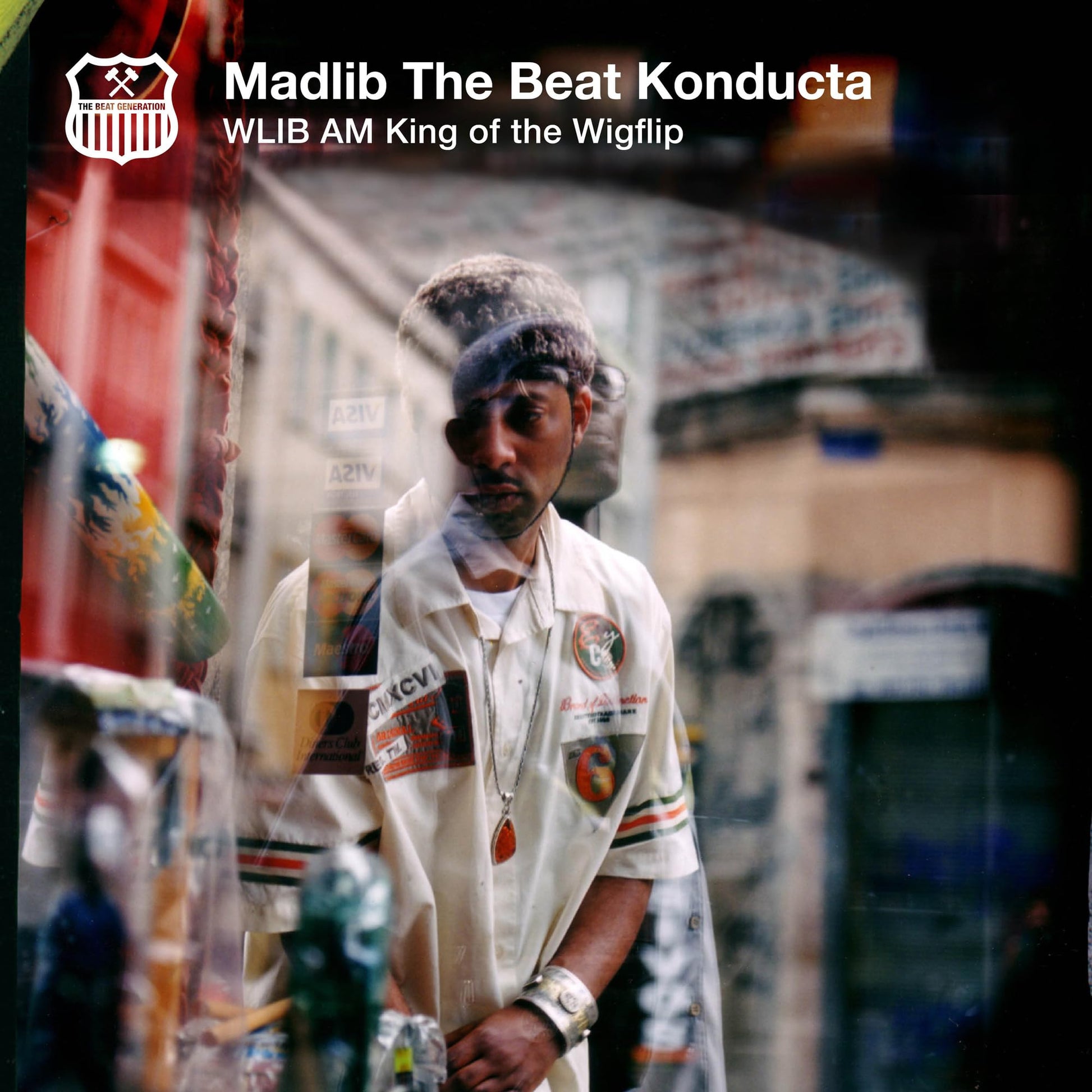 Vinyl album cover featuring Madlib, a man with dreadlocks, in a blurred, reddish photo.