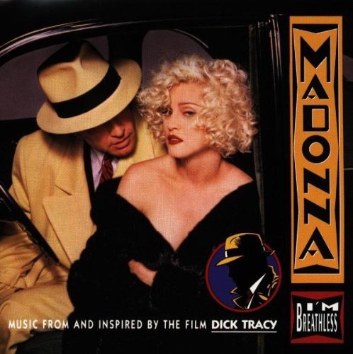 Madonna in a car, wearing a hat and looking at the viewer.