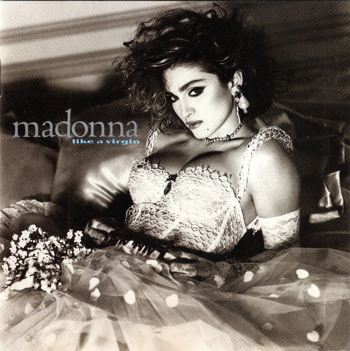 Black and white album cover featuring Madonna in a wedding dress and lace bustier.