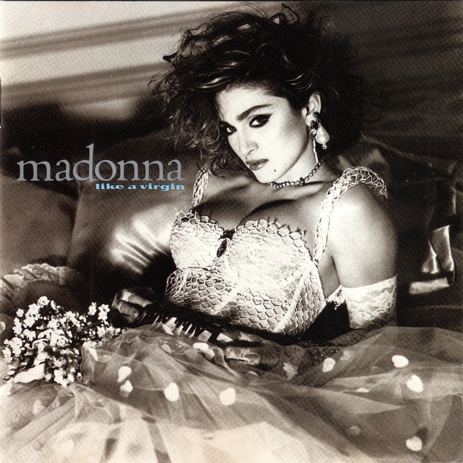 Black and white album cover featuring Madonna in a wedding dress and lace bustier.