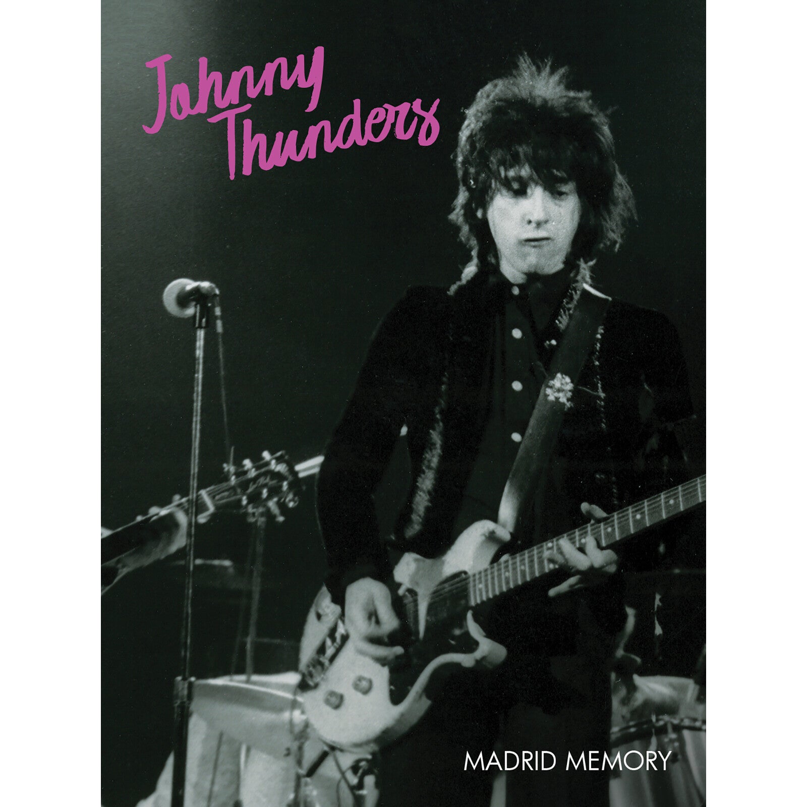 Johnny Thunders playing guitar on stage, DVD cover art.