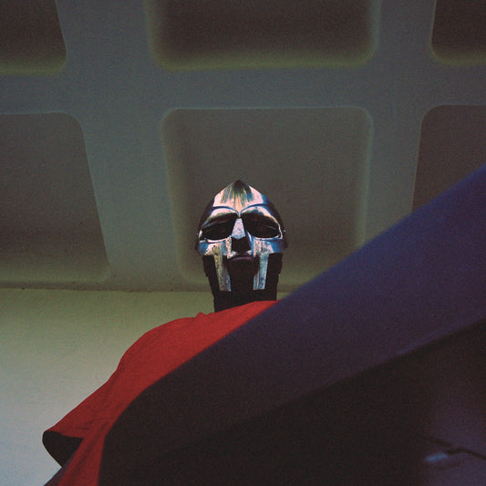 A person wearing a metallic gladiator-style mask looking down from a low angle.