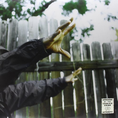 Madvillainy album cover: figure with outstretched hands before a wooden fence.