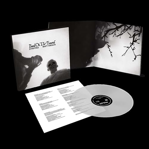 Open vinyl record with black and white album cover and lyric sheet.