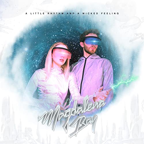 Magdalena Bay duo wearing visors, set against a cosmic, swirling background.