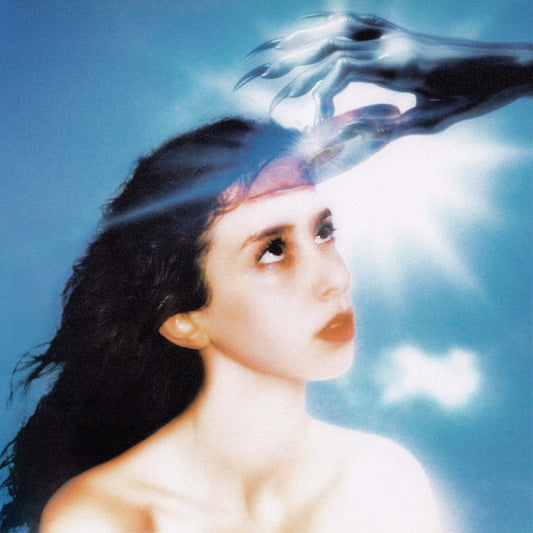 Woman with dark hair looks up, hands reaching from above.
