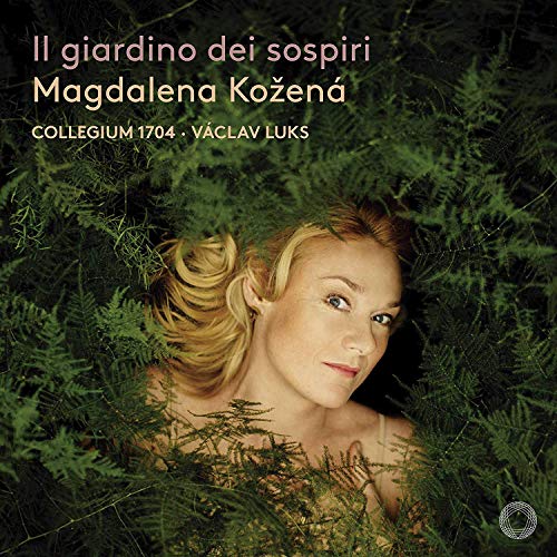 A woman lies in foliage, surrounded by greenery, on a music album cover.