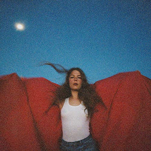 Maggie Rogers album cover: woman with long hair under a blue sky.