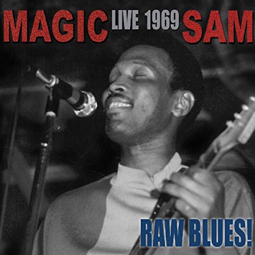 Black and white portrait of Magic Sam performing with a microphone.