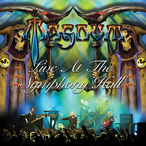 Magnum album cover: band performing on stage with ornate skull imagery.