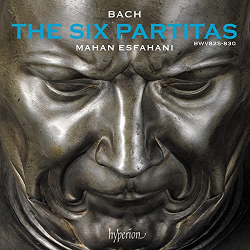 A CD cover featuring a close-up of a metal face sculpture with text overlay.