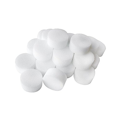 A pile of white, round, foam makeup sponges against a white background.