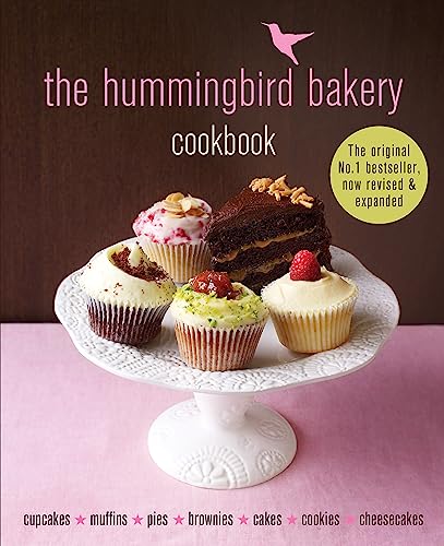 Cookbook cover with cupcakes, cakes, and a hummingbird illustration.