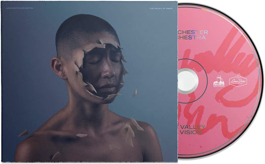CD case and disc showing a person with a crumbling face on blue background.