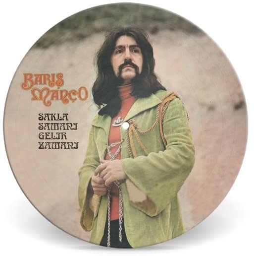 Vinyl record featuring Baris Manco in a green suit, portrait view.