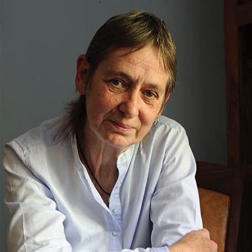 Portrait of a woman with short brown hair wearing a light blue button-down shirt.