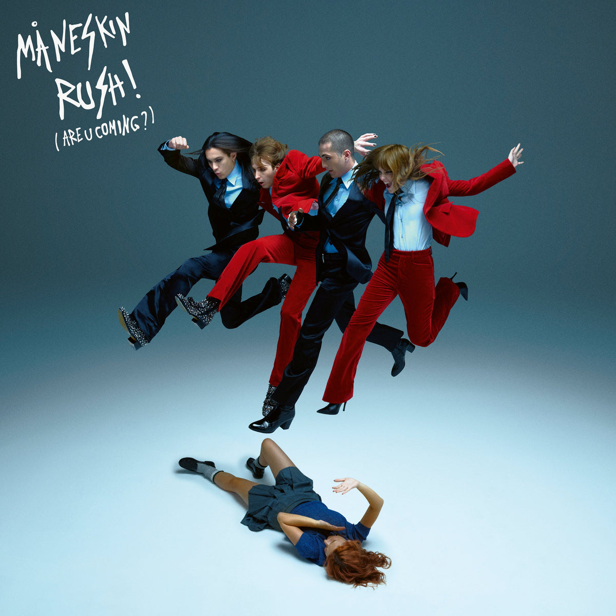Måneskin band members in suits mid-air, one person fallen below.