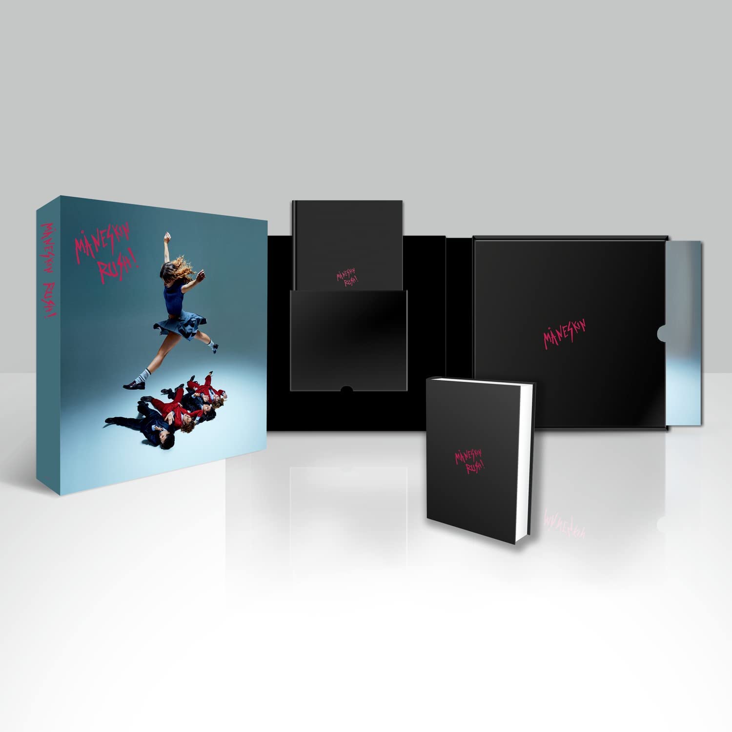 "Blue box with band members on cover, containing black boxes and a small book."