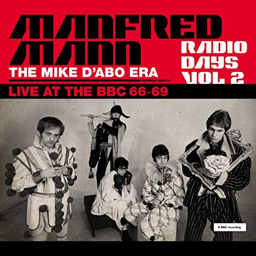 Manfred Mann band members in theatrical costumes on a red and white album cover.