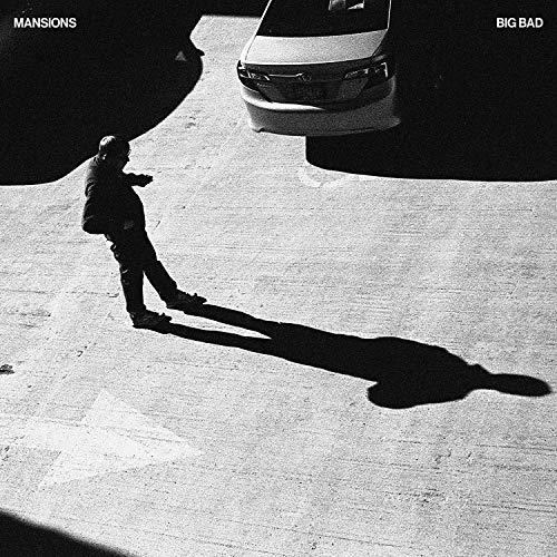 Black and white album cover featuring a man and a car in a parking lot.
