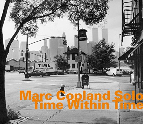 "Album cover with black-and-white city street scene and orange text."