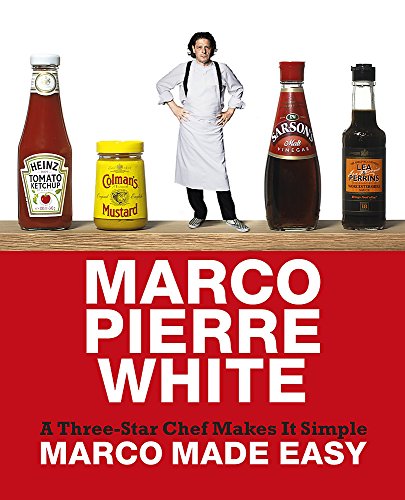 Chef Marco Pierre White stands with condiments on a wooden surface.