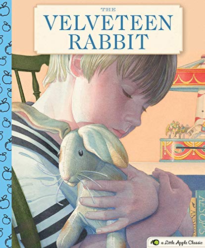 Boy lovingly holding a worn, plush rabbit on a striped blanket.