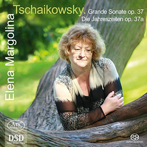 A woman leaning on a tree trunk, smiling, on a classical music CD cover.