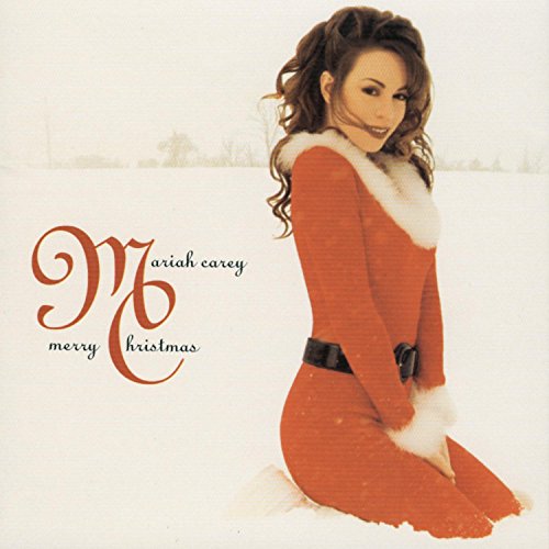 Mariah Carey wearing a red Santa-style dress kneeling in the snow on album cover.