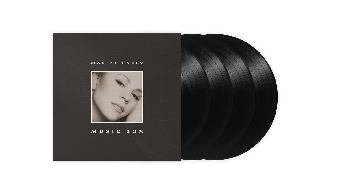 Mariah Carey Music Box album cover with three black vinyl records fanned out behind.