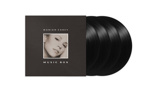 Mariah Carey Music Box album cover with three black vinyl records fanned out behind.