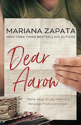 Book cover for "Dear Aaron" with handwritten red title and hand holding it.