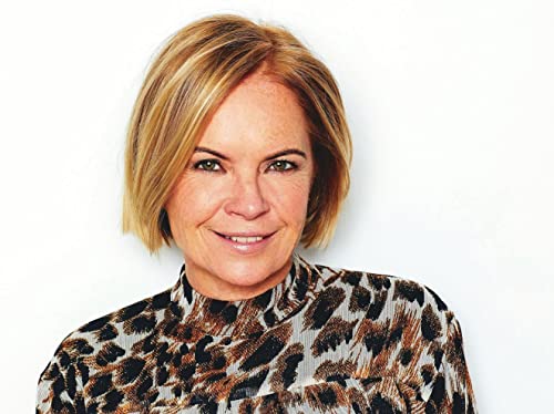 Close-up of a smiling woman with short, layered blonde hair.