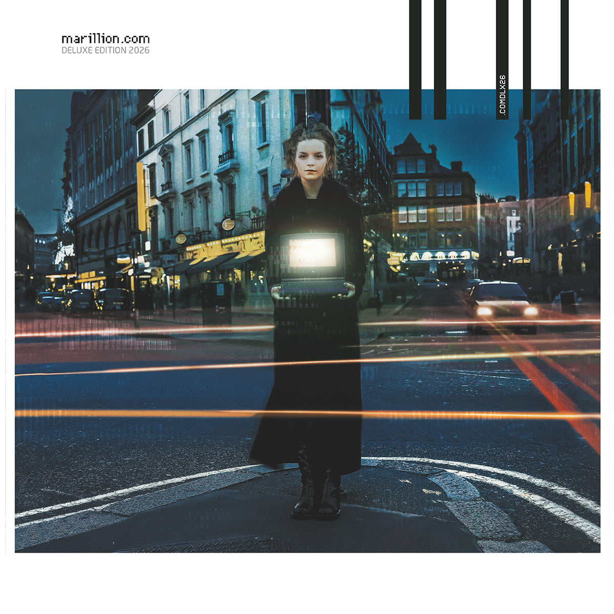 A person in a dark coat stands in a city street holding a glowing laptop.