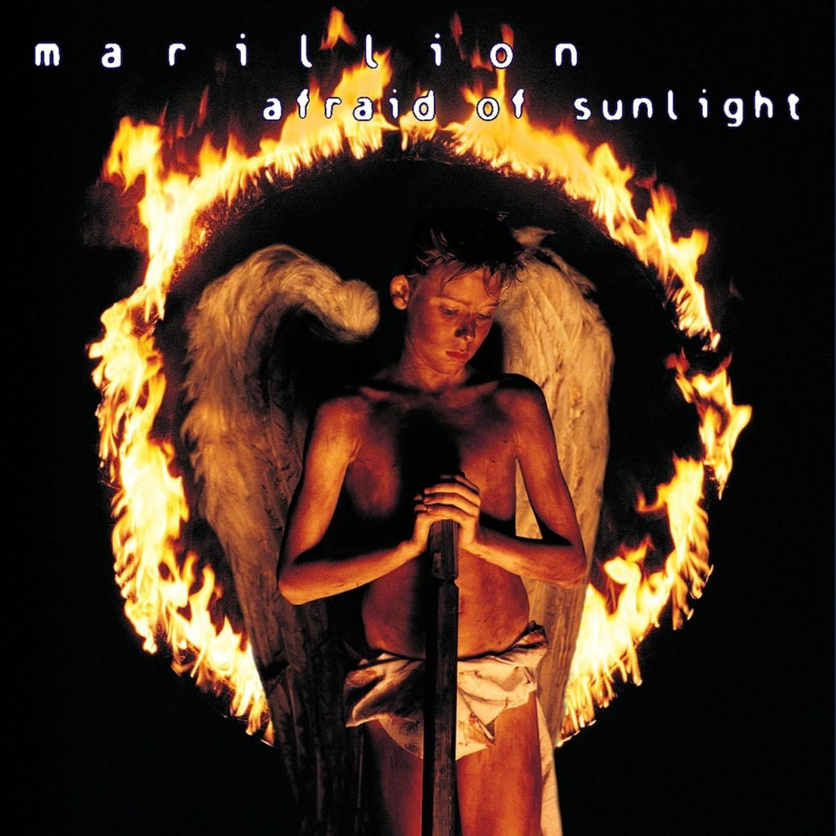 Boy with angel wings surrounded by flames, album cover art.