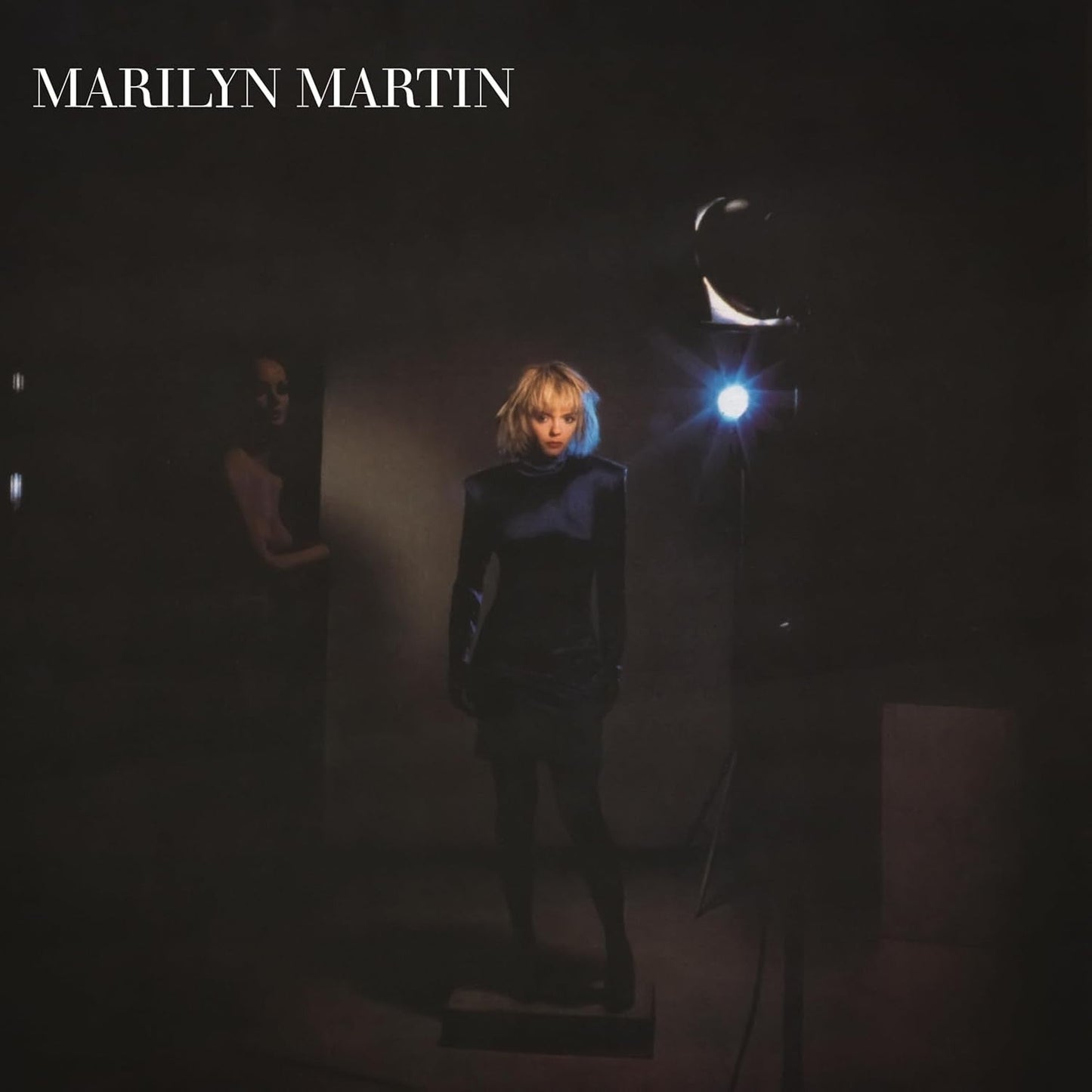 Marilyn Martin album cover: woman in black under bright studio light.