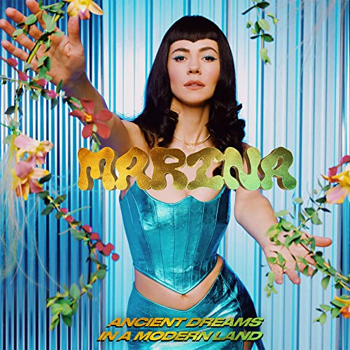 Marina album cover with artist in teal outfit, gold lettering, and flowers.